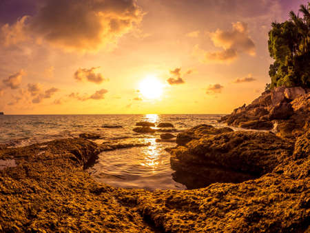 Spectacular view on the rocks of Surin Beach during sunset circa March, 2018 in Phuket, Thailand.の写真素材