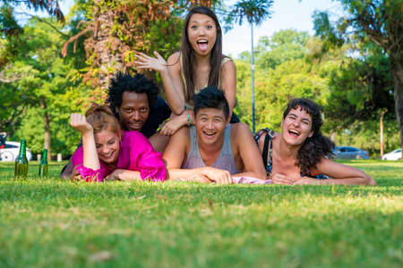 A happy group of friends enjoying a sunny day together in a garden.