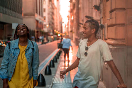 A traveling couple having fun in the city in the evening.の写真素材