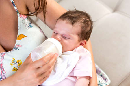 Closeup photo of a baby while her mother feeding her