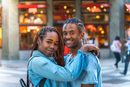 A loving couple hugging in the city.