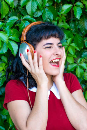 A woman listening to music on her headphones