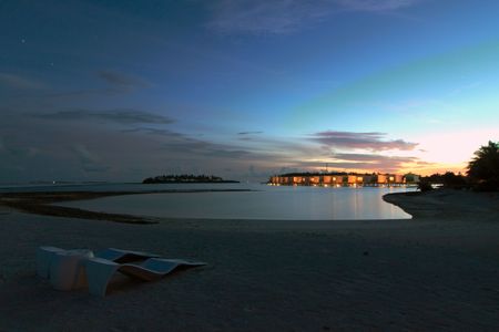 Sunset over water villas on Kandooma Island, Maldivesの写真素材
