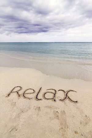 Word 'RELAX' written on the beach of Kandoomaの写真素材