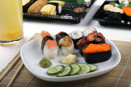 A plate of sushi with other sushi in the backgroundの写真素材