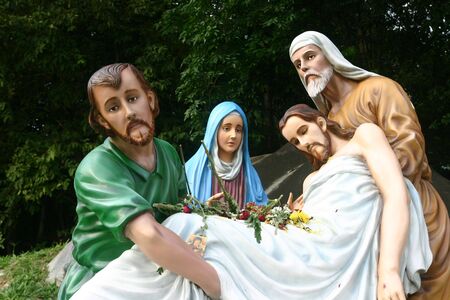 Statue of Jesus Christ being laid to the tomb, as Mary Magdalene watches on. These statues are located outside St. Anne's Church, Penang.の写真素材