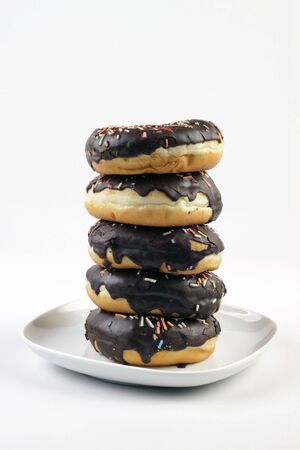 A stack of doughnuts on a white plateの写真素材