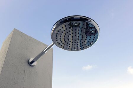 A modern "rain shower" shower head located outdoorsの写真素材