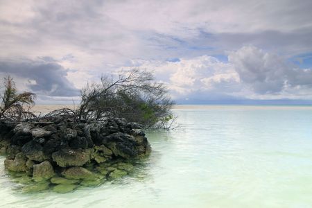 A man-made barrier of volcanic rocks on an isolated island at Maldivesの写真素材