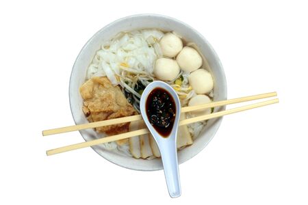 A bowl of Chinese flat noodles or 'koay teow' with fish balls, fish cakes, bean sprouts and 'fuchuk'の写真素材