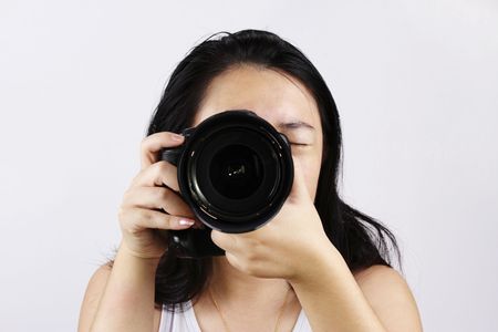 A female photographer with a DSLR cameraの写真素材