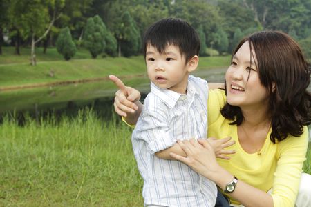 An Asian mother and her son at a public parkの写真素材