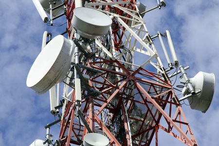 Close-up of a telecommunications tower with dramatic cloudsの写真素材