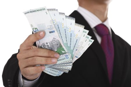 An Asian businessman holding some Malaysian currency.