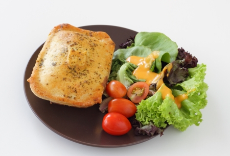 A plate of chicken pie with saladの写真素材