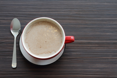 Top view of a cup of coffee on a wooden table with copy spaceの写真素材