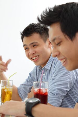 Two Asian men sharing a jokeの写真素材