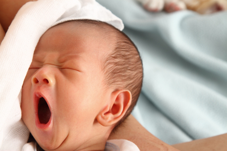 A baby boy yawningの写真素材