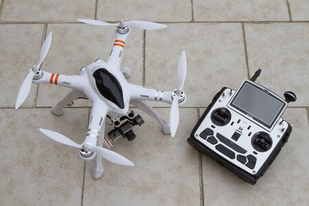 A quadcopter with camera gimbal system and radio transmitterの写真素材