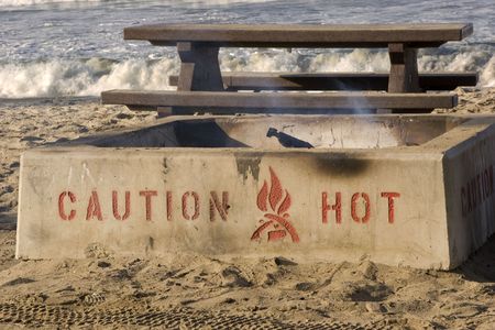 Smoldering campfire on the beachの写真素材