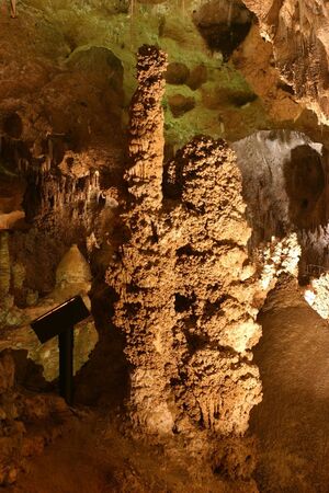 Rock formations inside Carlsbad Caverns National Park in New Mexico. Stalactites, stalagmites, and stone columns illuminated for displayby the park lighting system.の写真素材