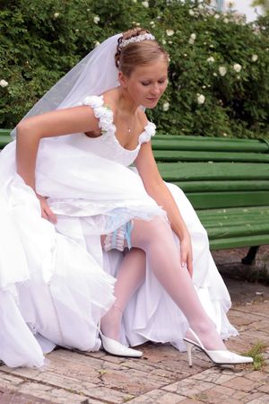 Smiling beautiful bride in traditional white weddiing dress の写真素材