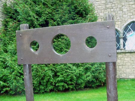 Some stocks stood in an English village by a church.の写真素材
