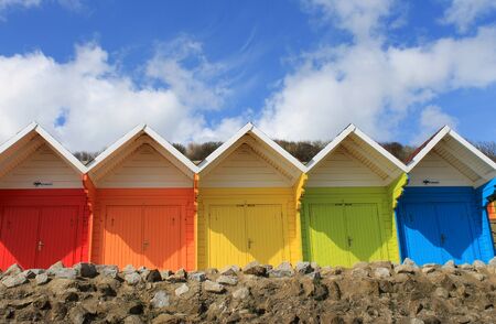 Row of colorful beach chalets with blue sky and cloudscape background, summer scene.の写真素材