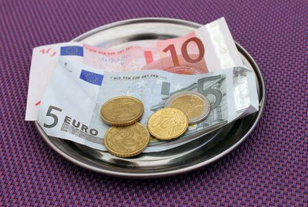 Euro tipsand payment for bill on on restaurant table.の写真素材