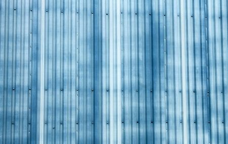 Abstract background of blue corrugated metal on warehouse building.の写真素材
