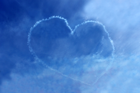 Vapor trail love heart in blue sky seen suring air display.の写真素材