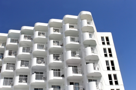 Low angle view of old white hotel building with blue sky background.の写真素材