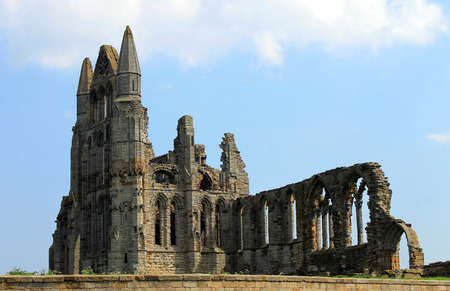 Scenic view of the ruins of Whitby Abbey with blue sky and cloudscape background.の写真素材