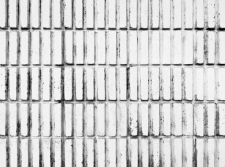 White vertical masonry brick wall with dirty and black stains.の写真素材
