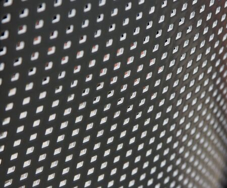 Plastic grille with small square holes for backgroundの写真素材