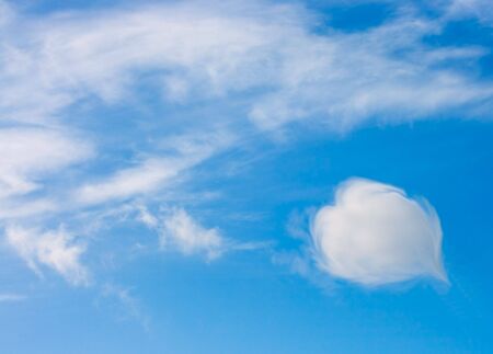 heart shaped cloud in a blue skyの写真素材