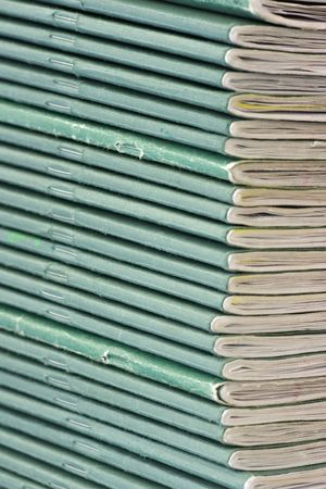 A pile of school exercise books with green coversの写真素材