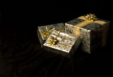 Wrapped Christmas gifts on a black backgroundの写真素材