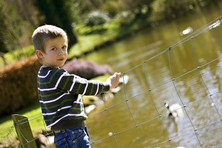 Candid close up portrait of a cute six year old boy looking worriedの写真素材
