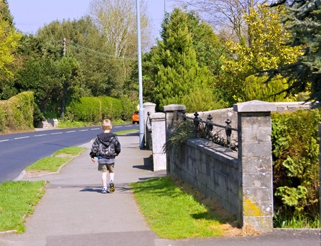 A young six year old boy walking home by himselfの写真素材