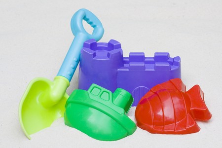 Children's beach toys laying in the sandの写真素材