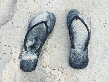 The black shoes on the sand  の写真素材