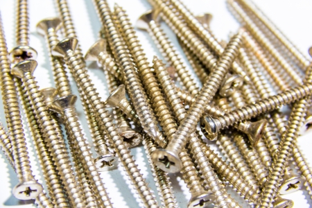 Gold screw on white background  