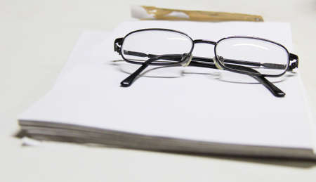glasses on the white paper  の写真素材