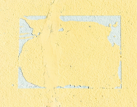 frayed yellow cement wallの写真素材