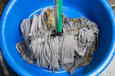 dirty mop in the basinの写真素材
