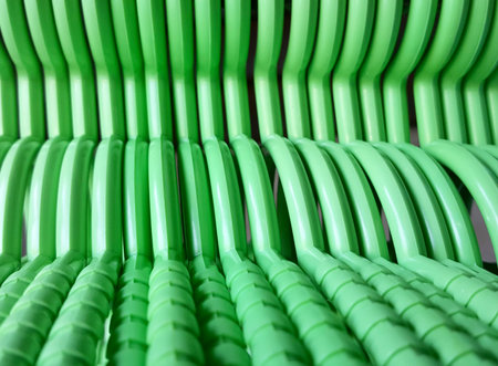 a photography of a green chair with a lot of green plastic chairs, there is a green chair that has many green chairs in itの写真素材