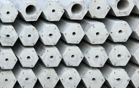 a photography of a pile of concrete blocks with holes in them, there are many cement hexagons stacked on top of each otherの写真素材