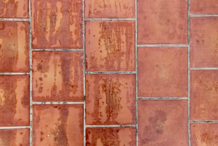 a photography of a red brick wall with a black cat sitting on it, brick wall with rusted paint and a...
