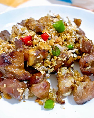 plate of food with meat and vegetables on it on a table.の写真素材
